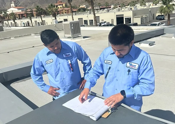 All Valley Air HVAC technicians working on a rooftop AC unit in the Coachella Valley